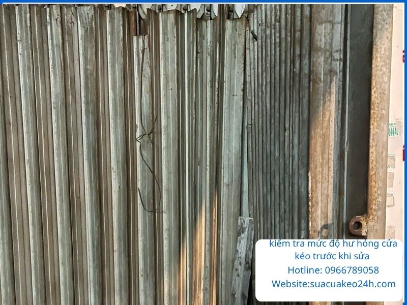 Khảo sát kiểm tra mức độ hư hỏng của cửa kéo bị cong móp trước khi sửa